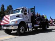 A thumb nail view of Grand Lake, Colorado during Constitution Week in September looking at the Alpine Lumber Truck rolling along Grand Ave. in the parade; click here to open a window with a larger picture.